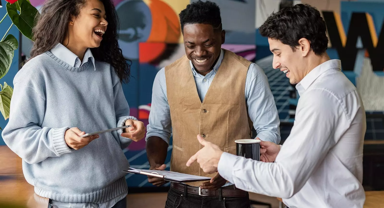 Drei Personen unterhalten sich und wirken glücklich